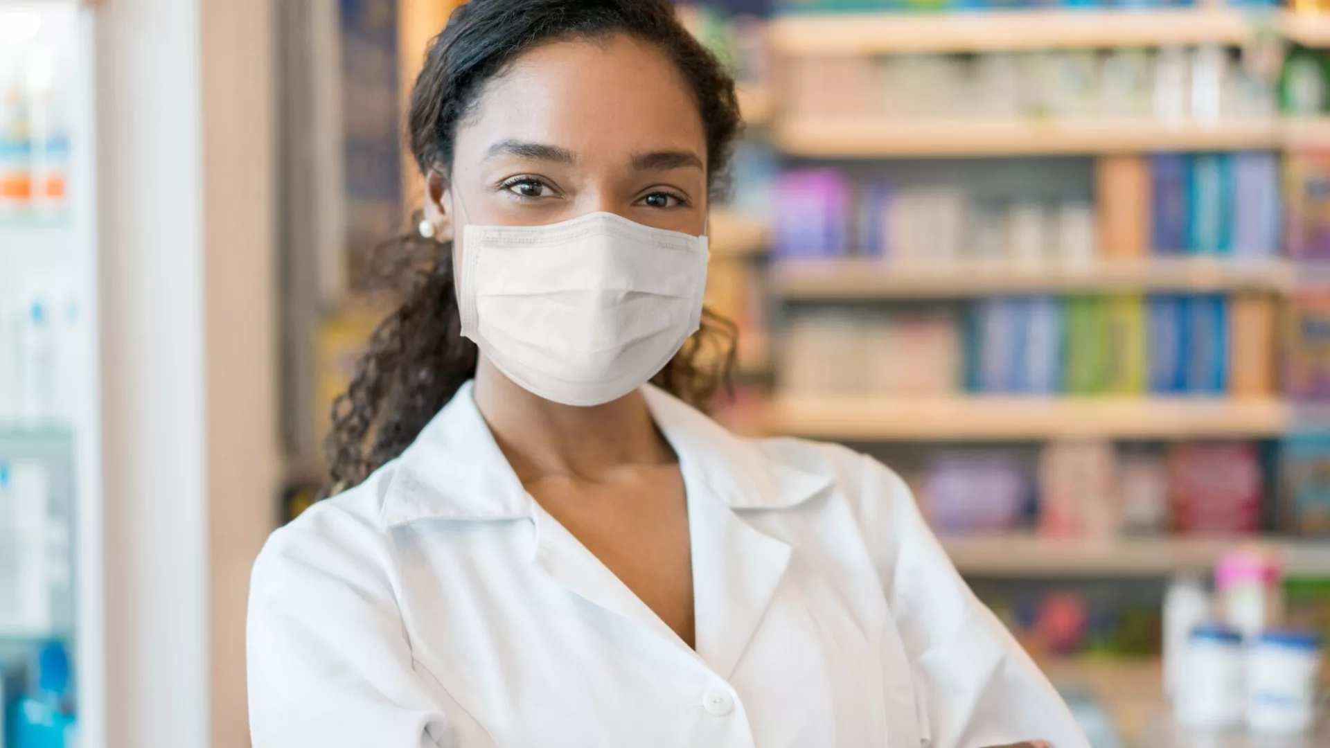 woman working at a pharmacy wearing facemask